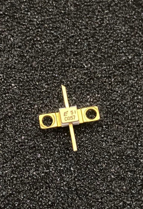 FLC057WG by Fujitsu RF transistor with gold-plated casing and dual pin connectors on black background