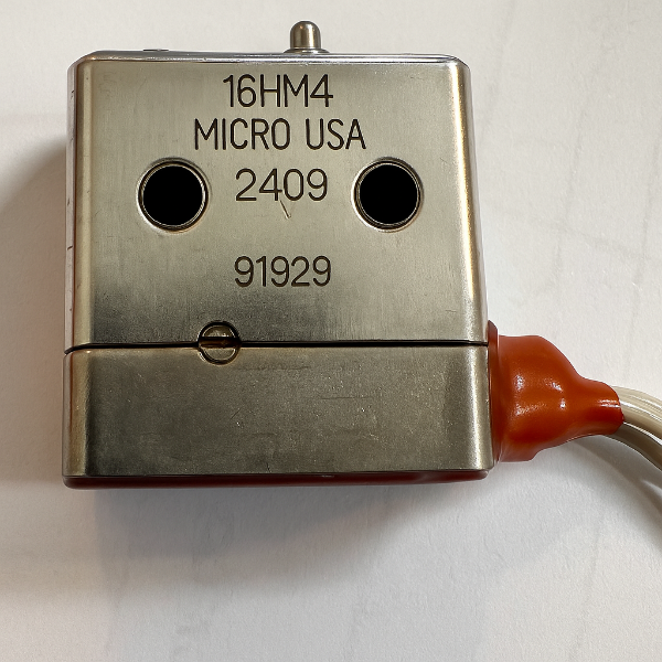 Metal component with '16HM4 MICRO USA' branding on a white background