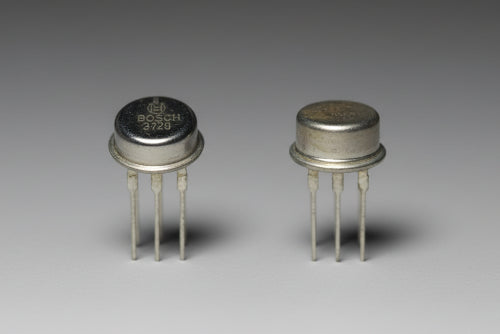 Two metallic buttons with star designs on a black background