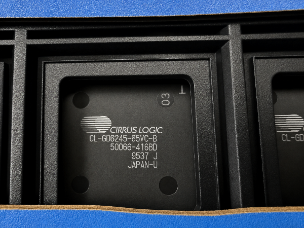 A close-up shot of a black Circus Logic CL-GD6245-65VC-B integrated circuit chip in a black carrier package, with white printed text and a blue surface visible around it.