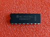 A Motorola MC14557BCL integrated circuit chip with the serial number KBAN0517, shown on a textured red background.