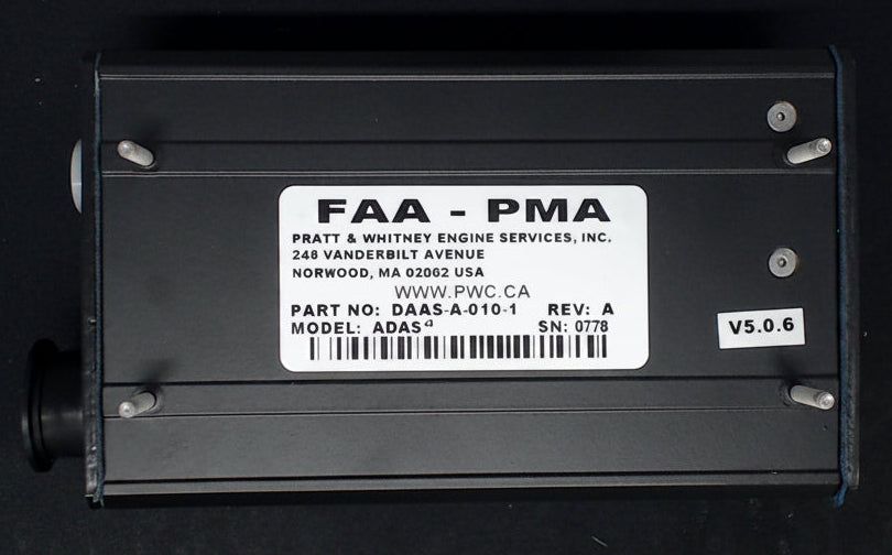 Black electronic module with FAA-PMA label on a dark background