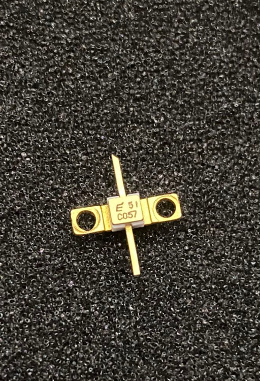 FLC057WG by Fujitsu RF transistor with gold-plated casing and dual pin connectors on black background