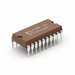 Brown integrated circuit with metallic pins on a white background